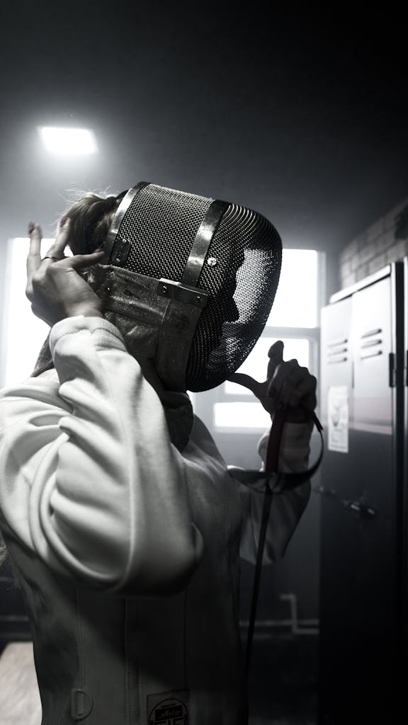 Person in White Coat Holding Black Leather Bag